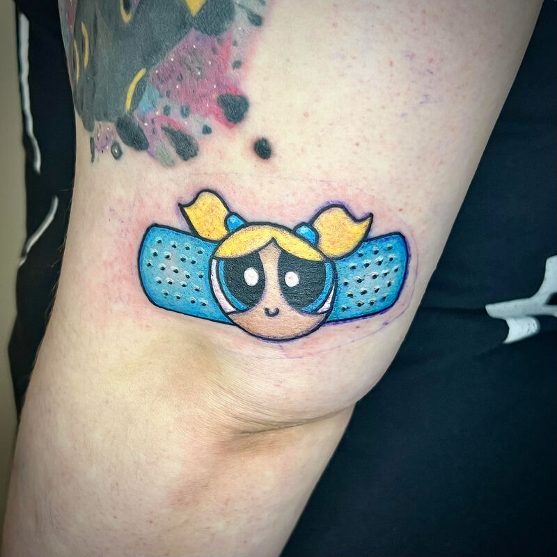 Power Puff Girls Bubbles band aid tattoo on an arm.