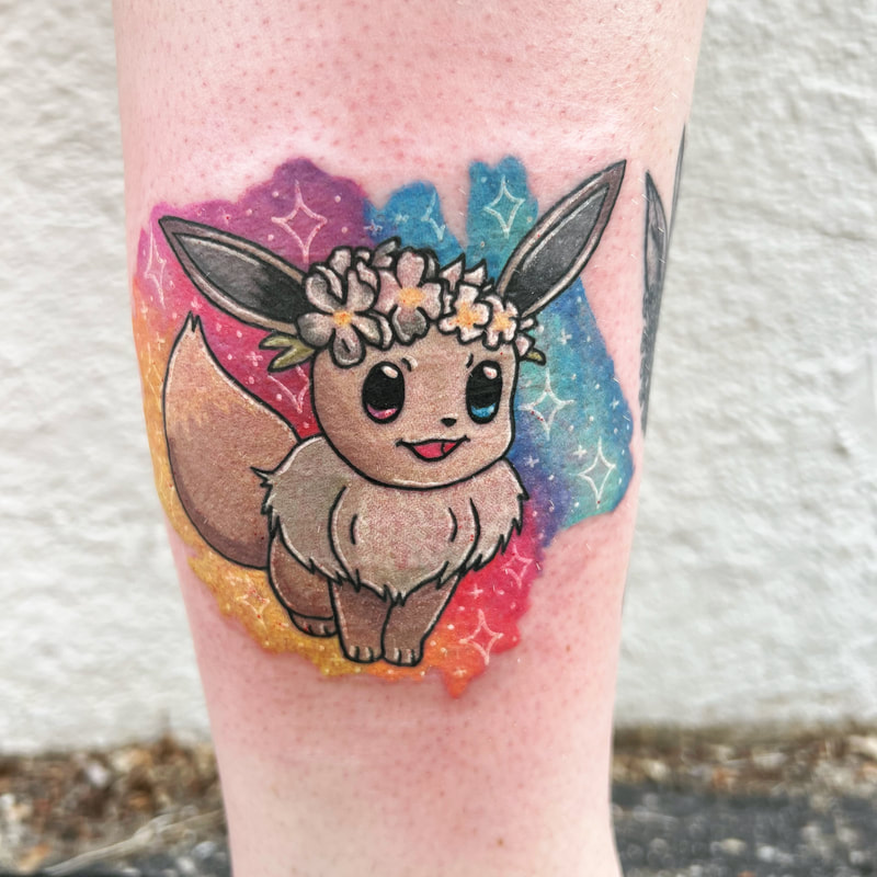 Rainbow watercolor shiny Eevee Pokémon tattoo with a flower crown on a woman's lower leg.