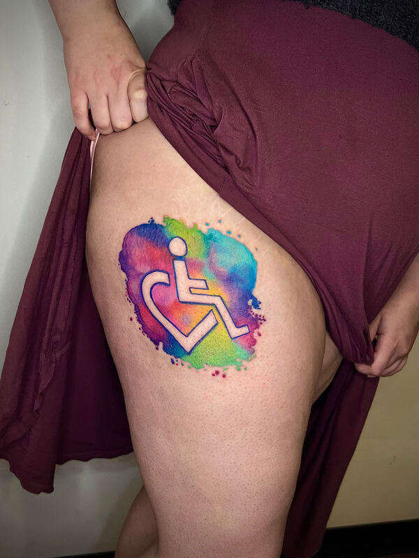 Rainbow watercolor handicap logo on a leg.