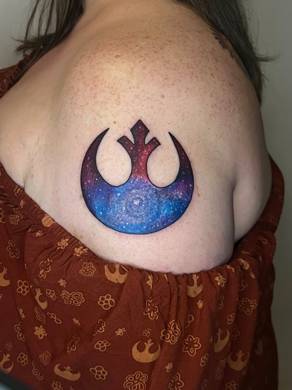 Star Wars rebel alliance logo with galaxy inside on an upper outer arm.